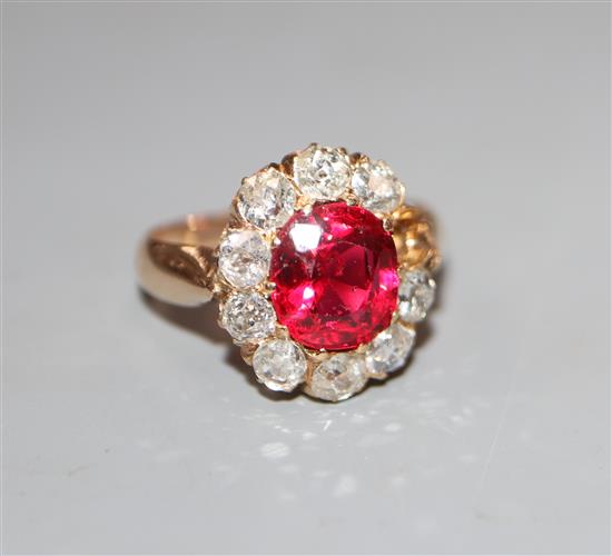 An early-mid 20th century yellow metal, red doublet and diamond set oval cluster ring, size K, gross 4.4 grams.
